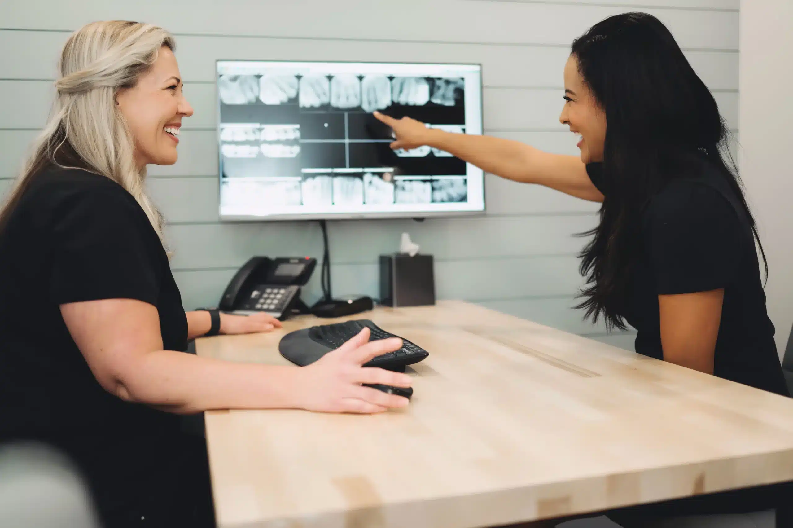 Team members reviewing dental X-rays together
