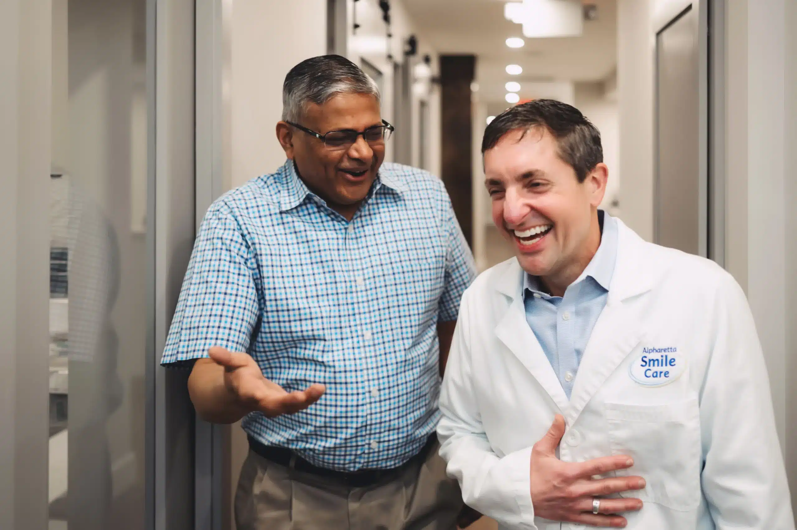 Dr. Worful laughing with a patient in the hallway