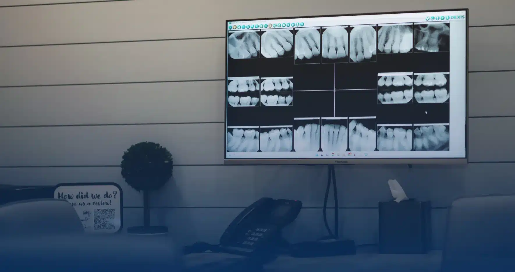 Treatment room with dental X-rays on the screen