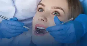 Dentist examining a patient's teeth with a mirror