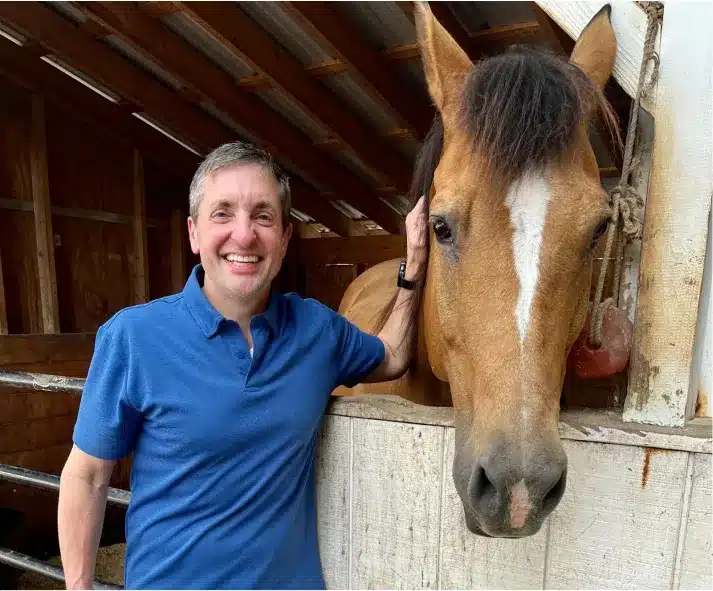Dr. Worful with a horse at a stable