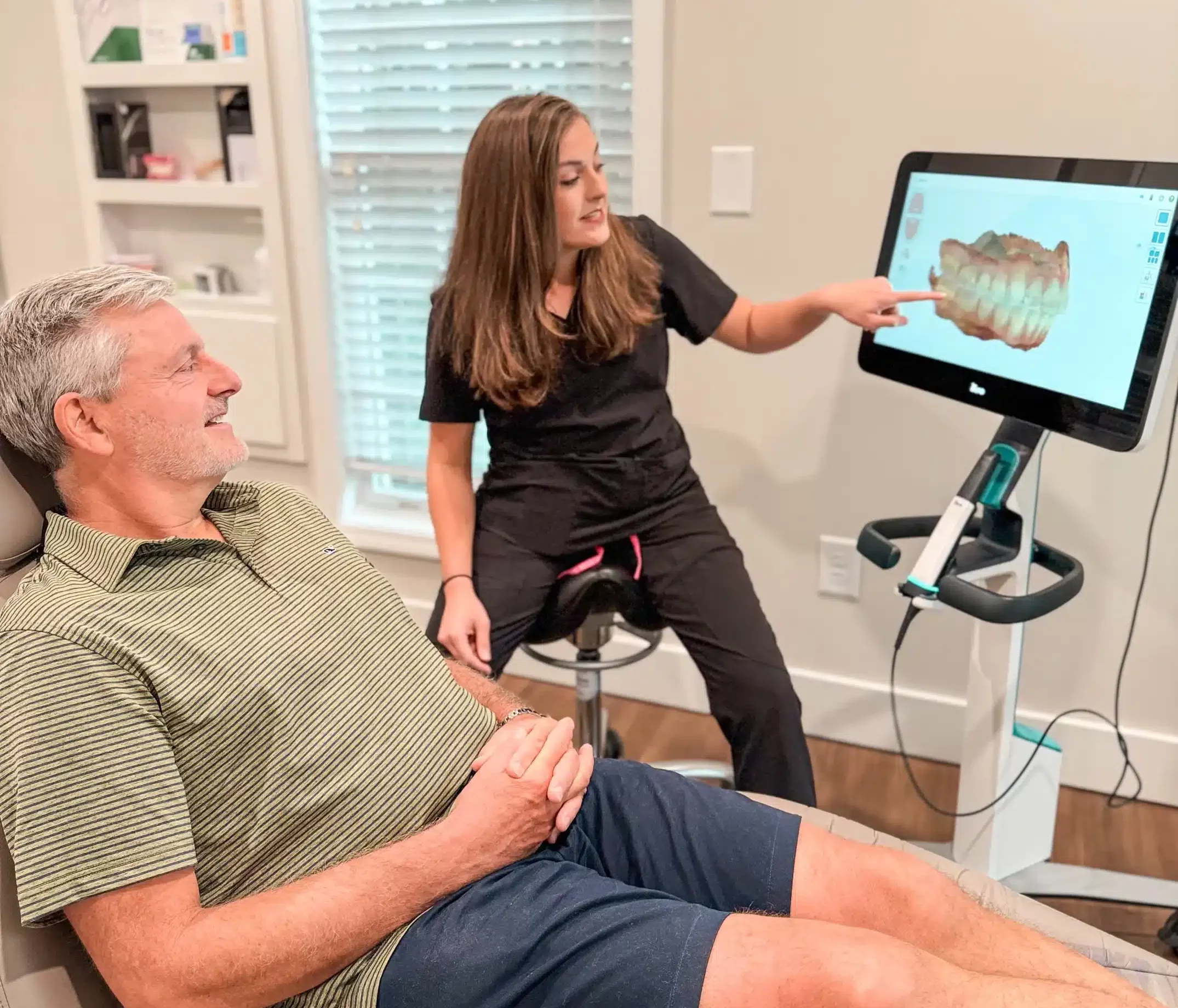 Hygienist showing a patient a 3D scan of his teeth