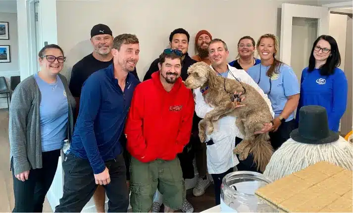 Alpharetta Smile Care team with community members and a dog