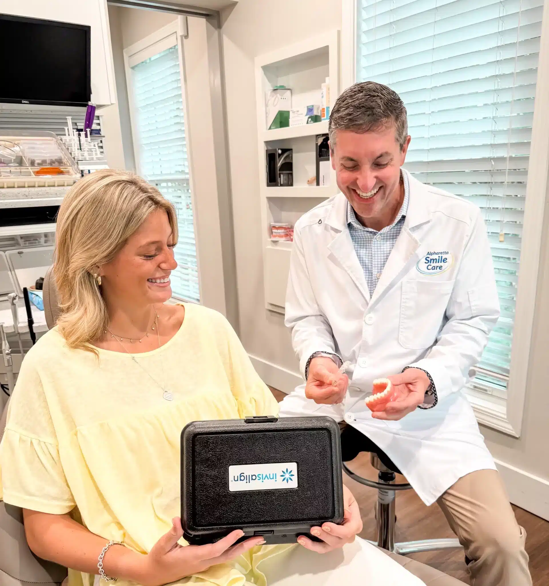Dr. Worful presenting an Invisalign kit to a patient