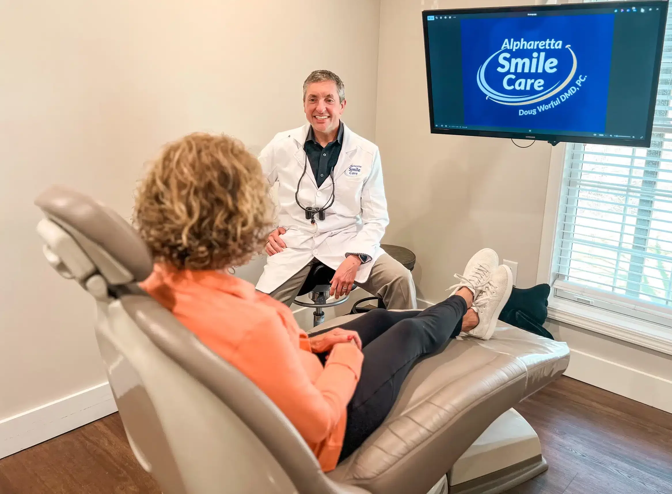 Dr. Worful talking with a patient in the treatment chair