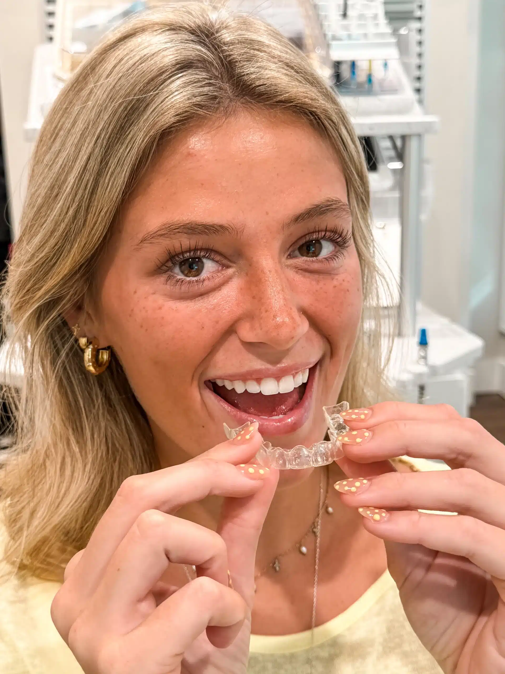 Young patient smiling with her Invisalign aligner