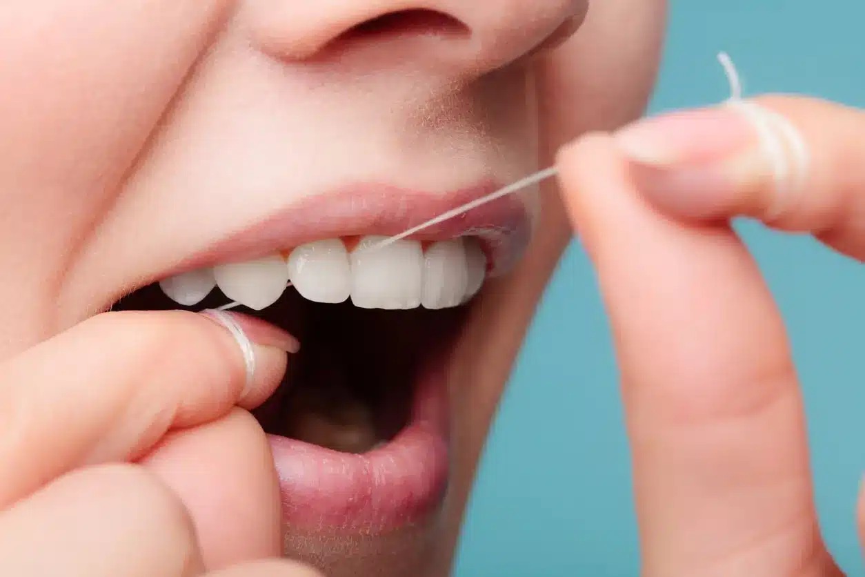 Woman flossing her teeth