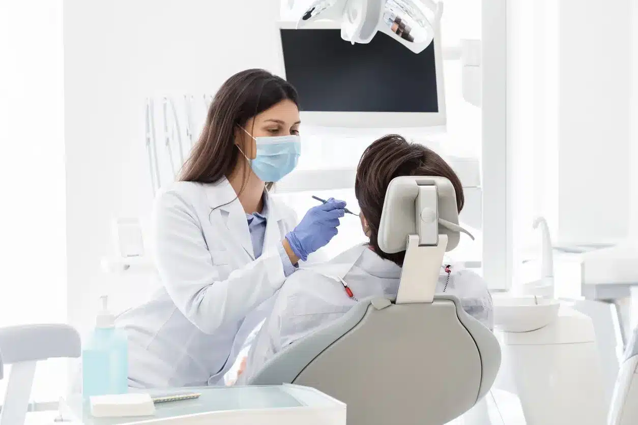 Dentist treating a patient in the dental chair