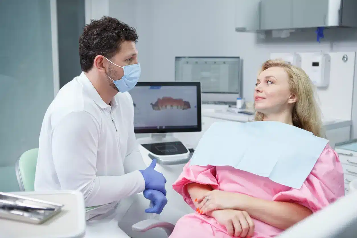 Dentist showing a patient a dental scan on screen